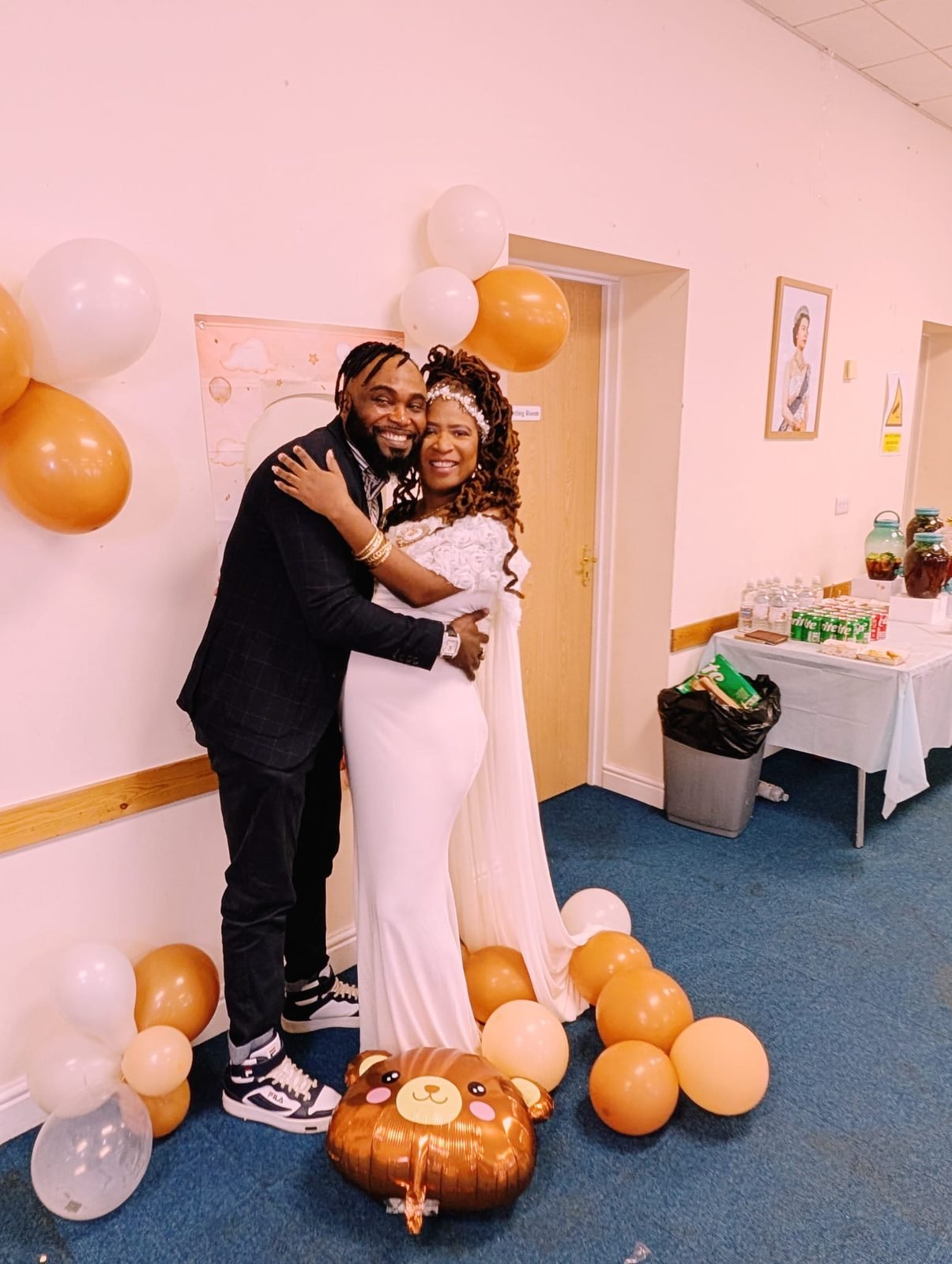 JayJay and Kisha embracing at the baby shower